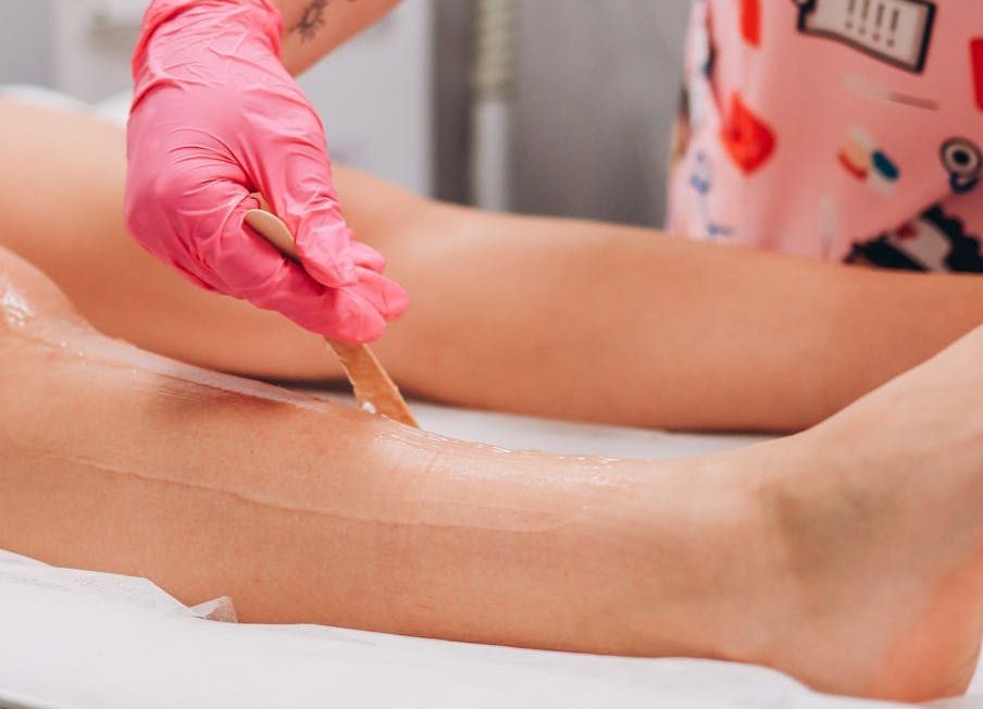 A professional beauty treatment waxing session in a salon setting.
